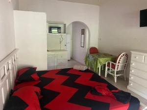 a room with a bed and a table and a room with a tableablish at Pondbottom Apartments Hotel in Saint James