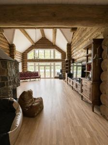a large living room with a couch and a large window at Private lakeside holiday house with fireplace, sauna, hot tub - Ezernams Dzintars in Valdemārpils