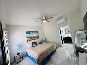 a bedroom with a bed and a ceiling fan at Rocky point beach house. in Puerto Peñasco +23 photos