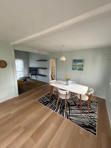 a dining room with a white table and chairs at Oneroa Manuka Residence in Waiheke Island