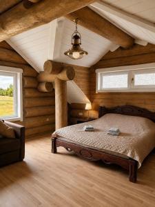 a bedroom with a large bed in a room with wooden walls at Private lakeside holiday house with fireplace, sauna, hot tub - Ezernams Dzintars in Valdemārpils