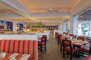 a restaurant with tables and chairs and a bar at Pueblo Bonito Rose Resort & Spa - All Inclusive in Cabo San Lucas