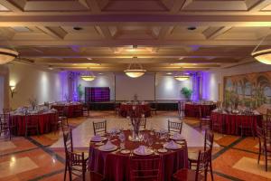 a banquet hall with red tables and chairs at Pueblo Bonito Rose Resort & Spa - All Inclusive in Cabo San Lucas +37 photos