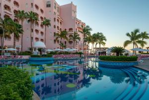 a pool at the resort with palm trees and buildings at Pueblo Bonito Rose Resort & Spa - All Inclusive in Cabo San Lucas