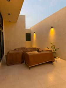 a room with several brown beds in a building at بالم هيلز Palm Hills in Baljurashi