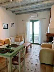 a living room with a couch and a table at MONI apartment in Perdika