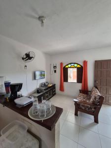 a living room with a table with glasses on it at Nataliana's House in Cabo Frio