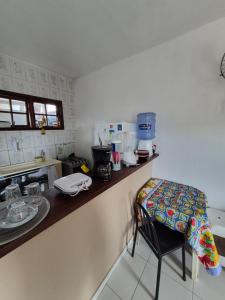 a kitchen with a counter and a chair in it at Nataliana's House in Cabo Frio