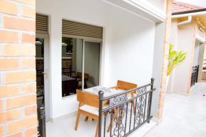 a balcony with a table and a chair at Velvet Suites in Kigali