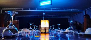 a table with wine glasses and a candle on it at Three pyramids Dahabiya in Esna