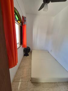 a room with a bed in a room with a window at Nataliana's House in Cabo Frio +2 photos