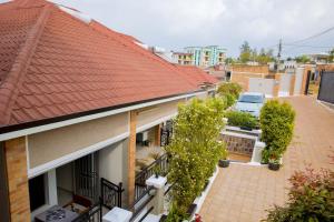 a house with an orange roof and a balcony at Velvet Suites in Kigali