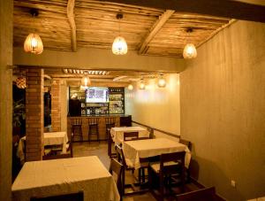 a restaurant with tables and chairs and a bar at Velvet Suites in Kigali