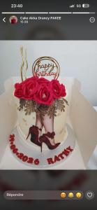 a birthday cake with a woman with red roses on it at Saro in Lourdes