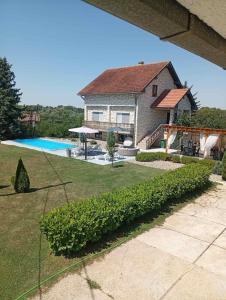 a large house with a swimming pool in a yard at OAZA Miokus in Miokus