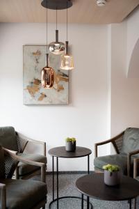 a living room with two chairs and a table at Aparthotel Saladina in Gaschurn