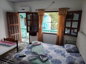 a bedroom with a bed and a large window at Hotel Alto Amazonas in Leticia