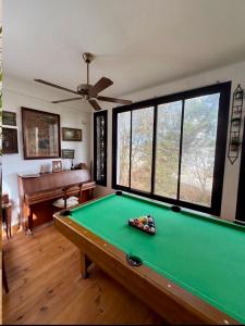 a room with a pool table and a piano at Maison Sahel - African Art & Coastal Serenity in Dakar