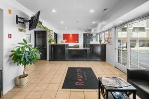 a living room with a couch and a rug on the floor at Ramada by Wyndham Ontario Airport & Convention Center in Ontario