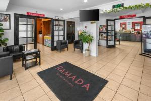 a waiting room with a pharmacy sign on a rug at Ramada by Wyndham Ontario Airport & Convention Center in Ontario +40 photos