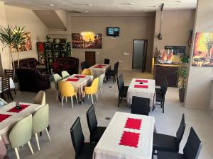 a dining room with tables and chairs in a restaurant at Center Side in Prizren