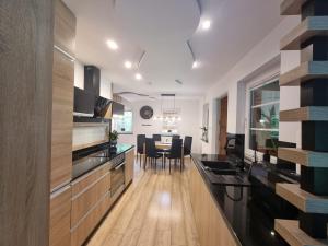 a kitchen with wooden counters and a dining room at Polana Jabłonka in Jabłonka +44 photos