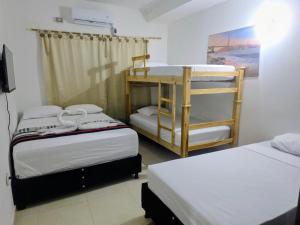 a room with two bunk beds in a room at Hotel Montserrat in Valledupar