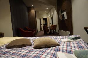 a bedroom with a bed with two pillows on it at LUNAS Apartmani 7 in Kopaonik