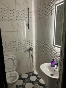 a small bathroom with a toilet and a sink at Center Side in Prizren