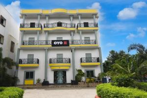 a white building with a oops sign on it at SPOT ON The Green Palace in Lālbāgh +21 photos