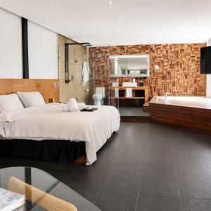 a bedroom with a large bed and a bath tub at Casa Caballero y Osio in Querétaro