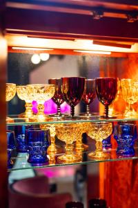 a group of glasses on a glass shelf at The Truitt in Saint Louis