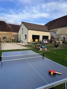 a ping pong table in front of a house at La Maison Belle in Germigny