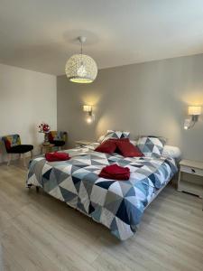 a bedroom with a large bed with a blue at La Maison Belle in Germigny