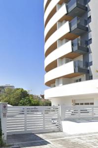a building with a white fence in front of it at La Vela Luxury Apartment in Pescara