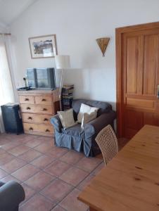 a living room with a couch and a dresser at Casaroc in Sella