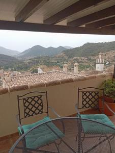 two chairs and a table on a balcony with a view at Casaroc in Sella +5 photos