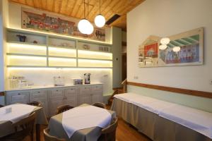 a dining room with two tables and a counter at Ξενώνας Λελέκι in Ayiá