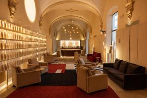 a lobby with couches and a bar in the background at Convent de la Missio - Grand Luxury Boutique hotel, Adults Only in Palma de Mallorca