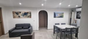 a living room with a table and a chair and a dining room at Sa Omu de S'Olia in Tertenìa