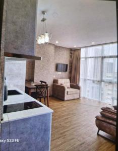 a kitchen and living room with a couch and a table at Archil in Batumi International Airport