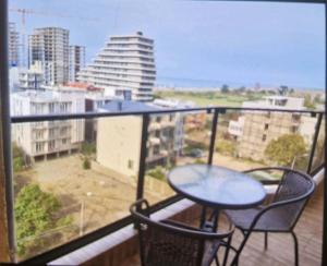 a balcony with a table and chairs and a view of a city at Archil in Batumi International Airport +4 photos