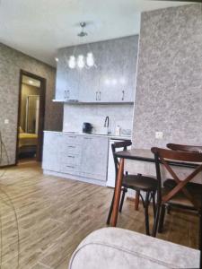a kitchen and dining room with a table and chairs at Archil in Batumi International Airport