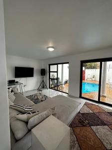 a living room with a couch and a tv at The White House - Zonnebloem in Cape Town