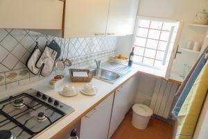 a small kitchen with a stove and a sink at Casa Dalia rifugio romantico in Montecatini Terme +32 photos