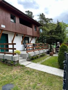a building with a bunch of benches in front of it at Domek wypoczynkowy Nad Brdą in Przechlewo