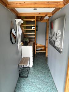 a room with a staircase and a table and a bench at Domek wypoczynkowy Nad Brdą in Przechlewo