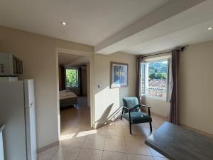 a living room with a chair and a window at Résidence Callas in Callas +7 photos