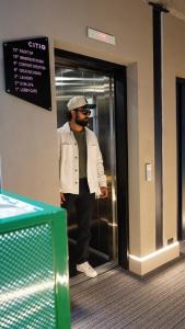 a man standing in a elevator in a building at CITIO Hotel - Laureles in Medellín