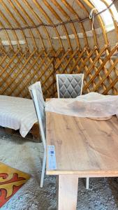 a laptop sitting on a wooden table in a yurt at ЭКО -Балык 
